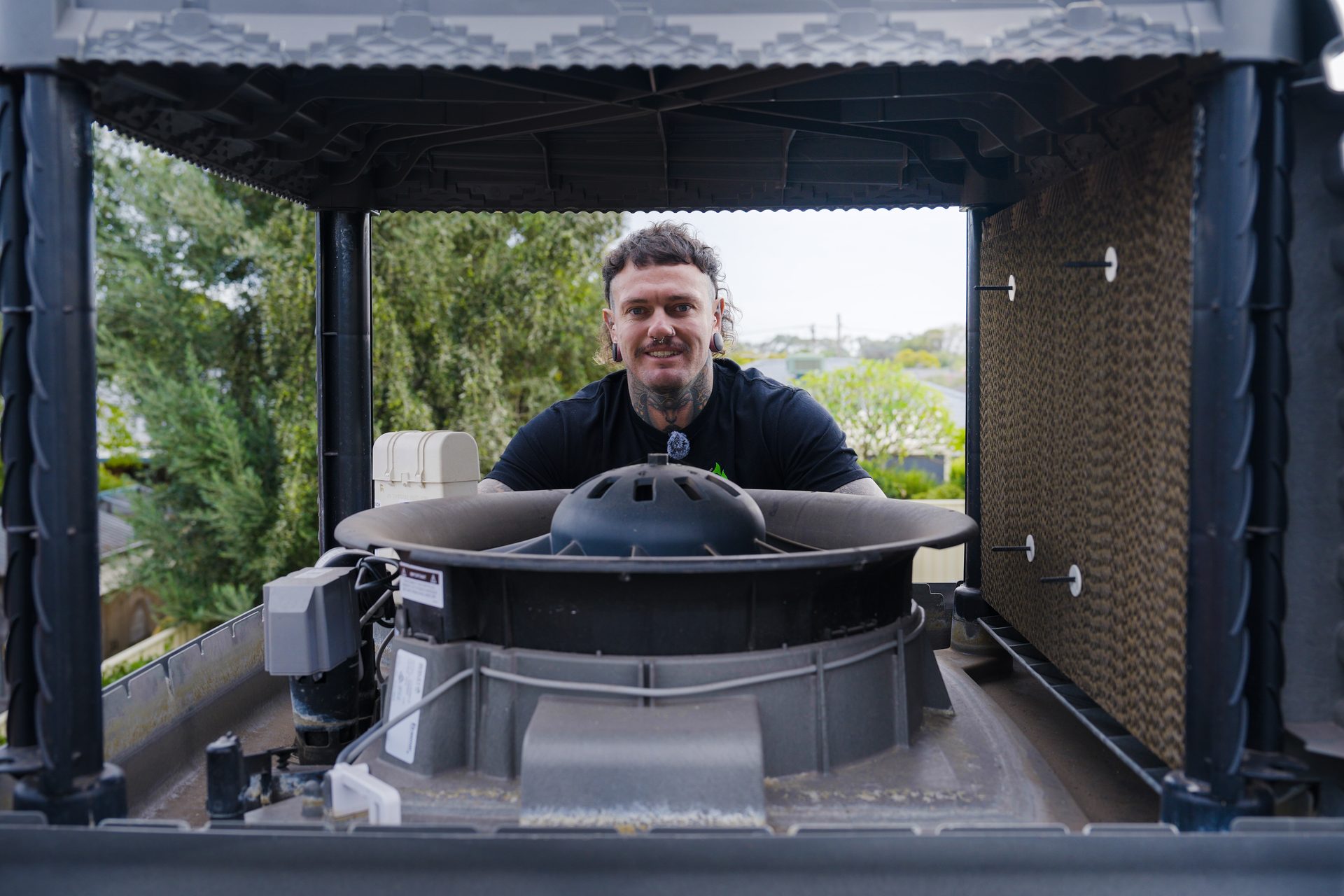 Ruben Bird inside an evaporative cooler unit on the roof