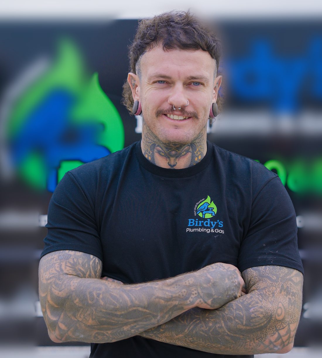 Ruben Bird, owner of Birdy's Plumbing & Gas, in front of the work truck